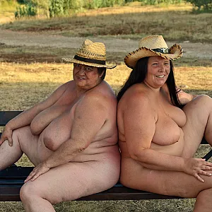 Two buxom lesbians posing naked on a bench 1 gallery image