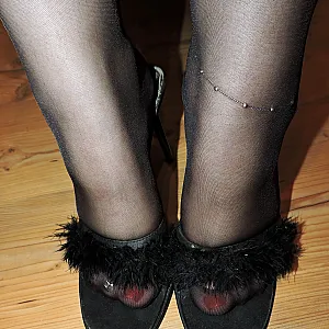 Sexy in Lederbody in Mules auf dem Bürostuhl Galeriebild