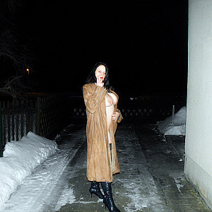 outdoors by night in a coat gallery image