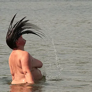 Water games at the nudist lake 1 gallery image