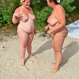 2 lesbians play in the sand 1-1 gallery image