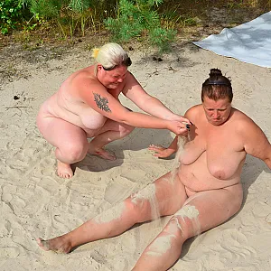 2 lesbians play in the sand 1-1 gallery image