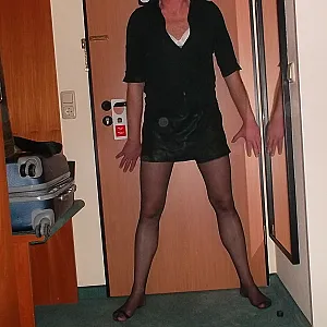 in female lingerie with a strapon in the hotelroom gallery image