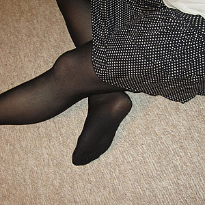 in a skirt and pantyhose gallery image