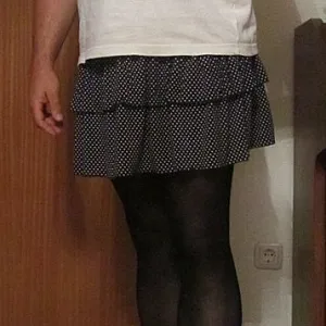 in a skirt and pantyhose gallery image