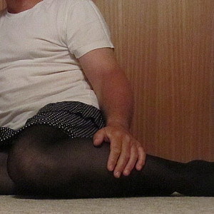 in a skirt and pantyhose gallery image