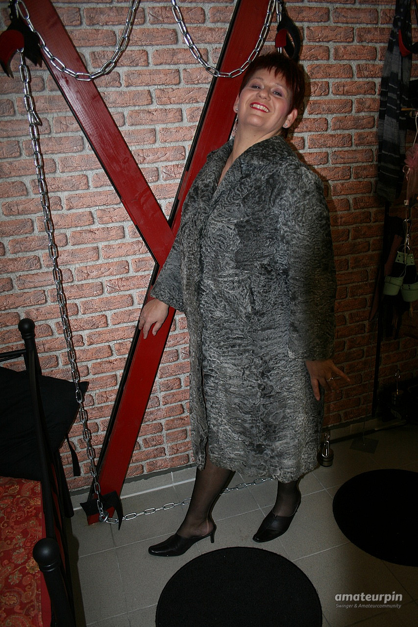 Posing in a gray fur coat gallery image