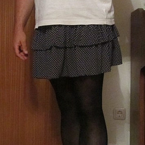 in a skirt and pantyhose gallery image