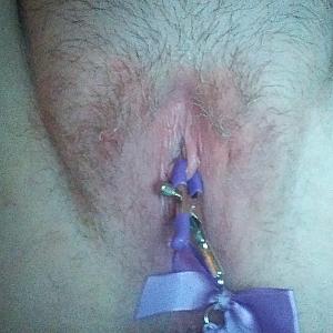 Purple nipple clamps on her pussy gallery image